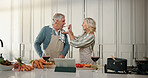 Cooking, taste and senior couple in kitchen for lunch, online recipe and prepare food for bonding in home. Tablet, retirement and old man and woman for meal prep, wine and help for anniversary dinner