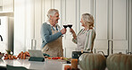 Mature, happy couple and cheers with wine in kitchen for cooking, meal prep or celebration in home. Man, woman or smile with glasses, toast or ingredients for food, online recipe or dinner in house