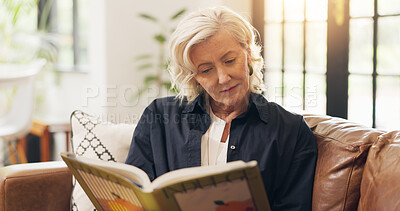 Buy stock photo Senior woman, reading book and happy on sofa, relax and literature in living room at apartment. Person, smile and novel on couch in lounge for learning, poetry or fiction story with flare at house