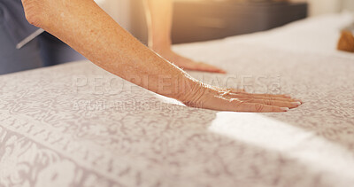 Buy stock photo Hands, person and cleaning bed at house to start day, dusting bedding and household chores. Mature woman, sheets and tidy bedroom for hygiene, blanket maintenance and organizing duvet of housekeeping