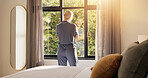 Morning, thinking and woman in bedroom, window or start of day in pajamas, sunshine and view on trip. Back, reflection and person with scenery in hotel room, peace and memories on holiday and calm