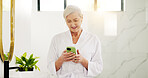 Smile, woman and reading with phone in bathroom for morning news, texting and scroll social media. Robe, home and mature person with mobile app for online search, communication or check notifications
