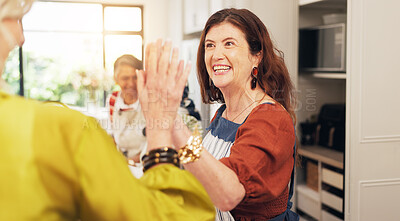 Buy stock photo Cooking class, mature friends and high five in kitchen for recipe success, culinary skills and bonding. Social reunion, happy women and celebration for meal support, learning and hosting dinner party