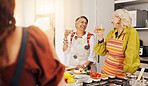 Cooking, kitchen and mature women with alcohol for bonding, conversation or culinary lesson. Happy, social reunion and senior friends with cheers, toast and food for learning recipes together in home