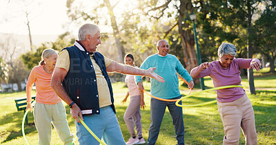 Buy stock photo Senior people, park and exercise with hoop for active retirement, wellness class or laugh. Elderly friends, ring and fitness outdoor, funny joke or workout for balance with group for cardio health