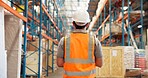 Logistics, inspection or man in storage warehouse for inventory check, shipping or stock distribution. Supply chain, quality control or worker with helmet for depot evaluation, monitor safety or back