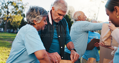 Buy stock photo Volunteer, outdoor and mature people with packages for food drive, charity event and donation. Helping, teamwork and group with bags for outreach program, community service and nonprofit in park