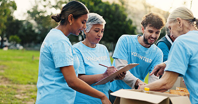 Buy stock photo Woman, volunteer and writing with clipboard at park for donation, talk and notes for social responsibility. People, team and help with checklist, review or planning with sign up at charity event