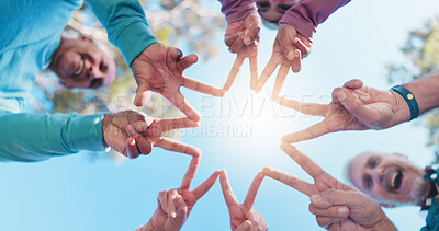 Buy stock photo Senior people, hands and star for collaboration, solidarity or fitness support in outdoor park. Blue sky, happy group and friends together for motivation goals, mission or workout exercise below