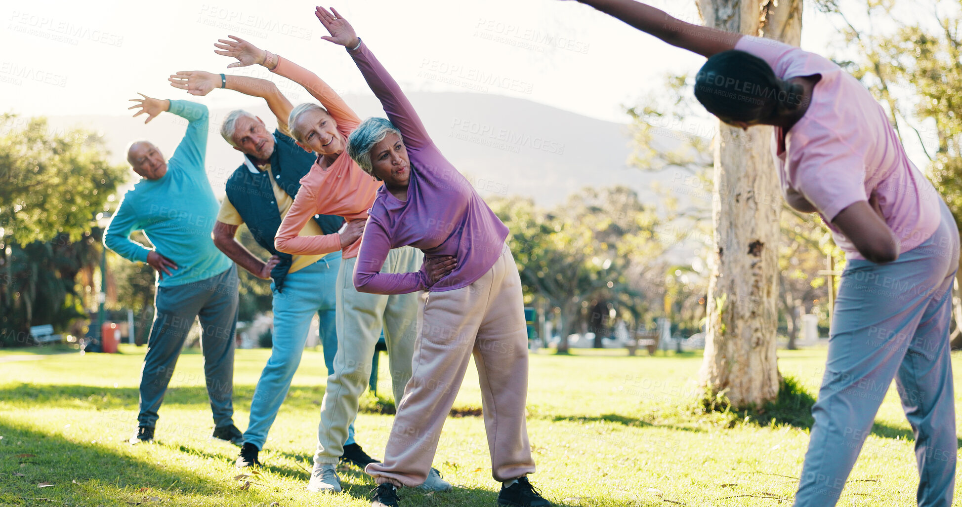 Buy stock photo Class, stretching and instructor with old people in park for wellness, workout or mobility exercise. Joint friendly training, retirement and learning with senior men and women outdoor for warm up