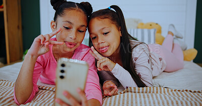 Buy stock photo Smile, children and relax with selfie on bed for photography, social media post and bonding together. Happy, girls and profile picture for family blog, siblings memory and weekend in home bedroom