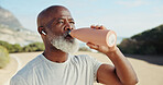 Fitness, drink water and senior man with earphones for audio, wellness and health on break. Hydration, thirsty runner and black person with bottle for electrolytes, exercise recovery or music outdoor