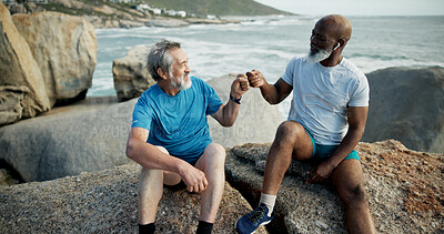 Buy stock photo Fitness, rest or people at beach with fist bump, support or cardio break in finished workout. Exercise, mature or friends at ocean with gesture, training recovery or motivation in performance goals.