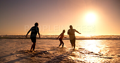 Buy stock photo Sunset, shadow and friends at beach with fun, bonding and vacation freedom on tropical island. Travel, ocean and senior people in water with adventure, playful in waves and summer evening in Cancun.