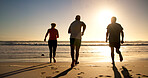 People, fitness or running with beach sunset for workout, cardio exercise or outdoor challenge. Back view, active or group of friends with sun on ocean coast for physical activity, health or wellness
