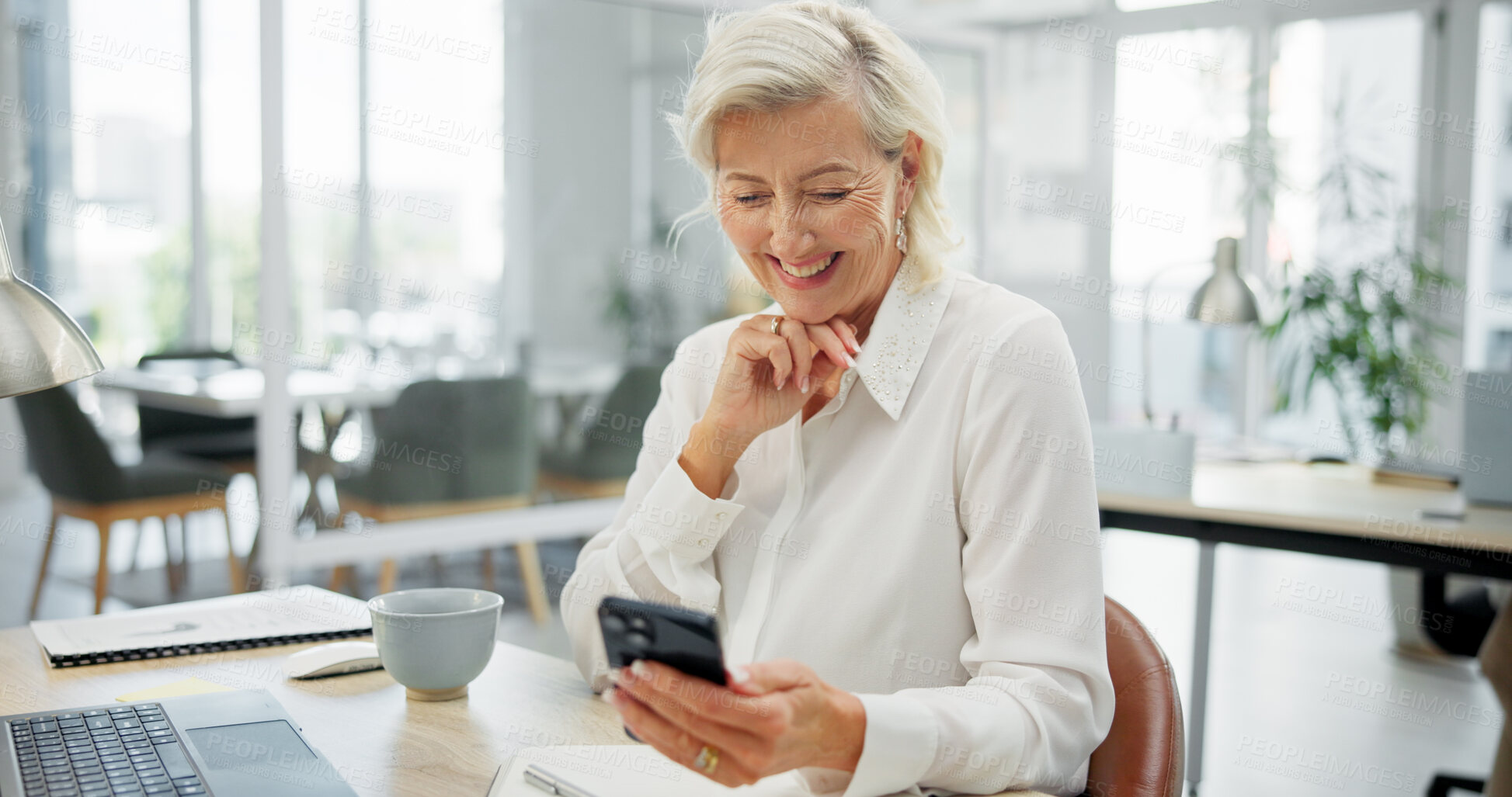 Buy stock photo Mature woman, phone and happy at office, texting or feedback for investment at company. Person, financial advisor and broker with smartphone, smile and fintech on mobile app for consulting at agency