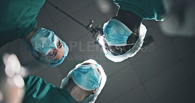 Buy stock photo Below, people and doctors in theatre at hospital for surgery, medical procedure and critical condition. Pov, team and surgeon discussion for emergency operation, organ transplant and healthcare risk