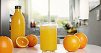 Nutrition, bottle or glass in kitchen with orange juice, antioxidant or vitamin benefit in morning drink. Organic, hydration or fruit in house for digestion, gut health or detox in breakfast beverage