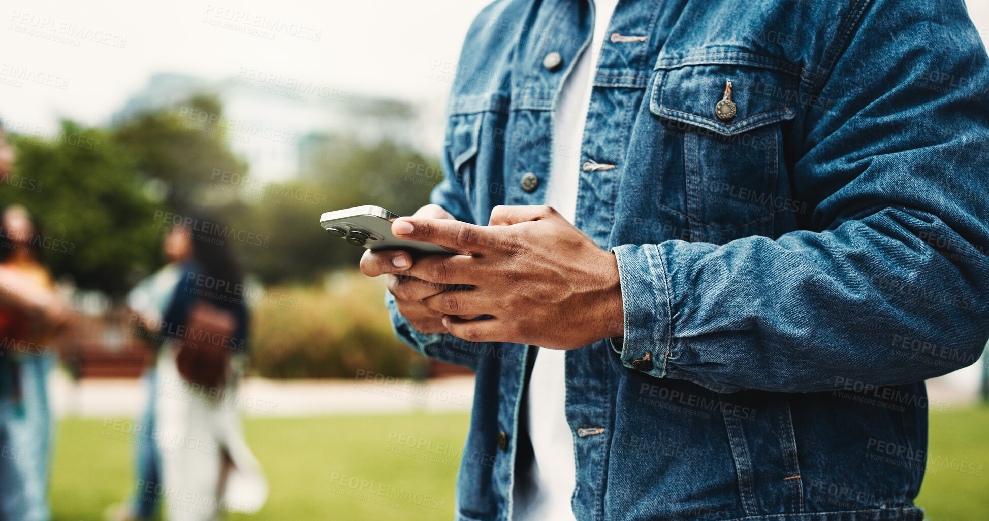 Buy stock photo Man, student and hands with phone on campus for online chatting, social media or texting in park. Closeup, male person or user typing with mobile smartphone for app, scholarship or news in college