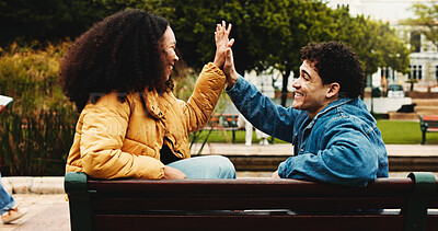 Buy stock photo Campus, students and couple with smile, high five and bonding together with study support. Outdoor, university or happy people on bench, gesture or celebration for scholarship, success or achievement