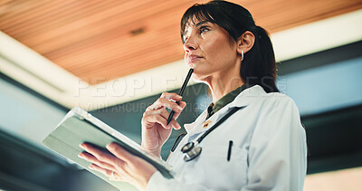 Buy stock photo Thinking, doctor and woman with tablet in clinic for medical info, problem solving or telehealth. Tech, healthcare and mature person with thoughts in hospital for planning, decision and low angle