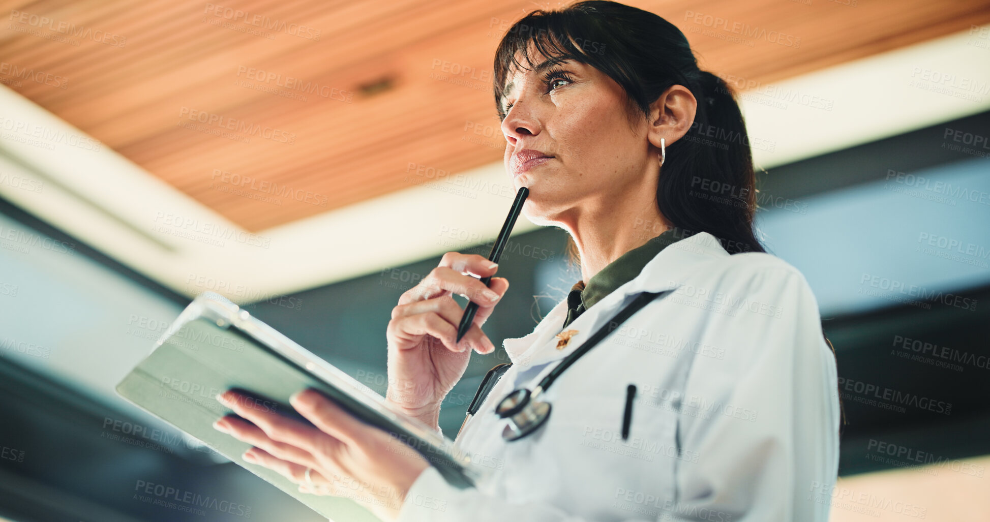 Buy stock photo Thinking, doctor and woman with tablet in clinic for medical info, problem solving or telehealth. Tech, healthcare and mature person with thoughts in hospital for planning, decision and low angle