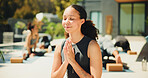 Yoga, woman and prayer hands at resort for meditation, spiritual awareness and chakra healing. Zen, yogi or person outdoor in wellness retreat with mudra for inner peace, mindfulness or namaste pose.
