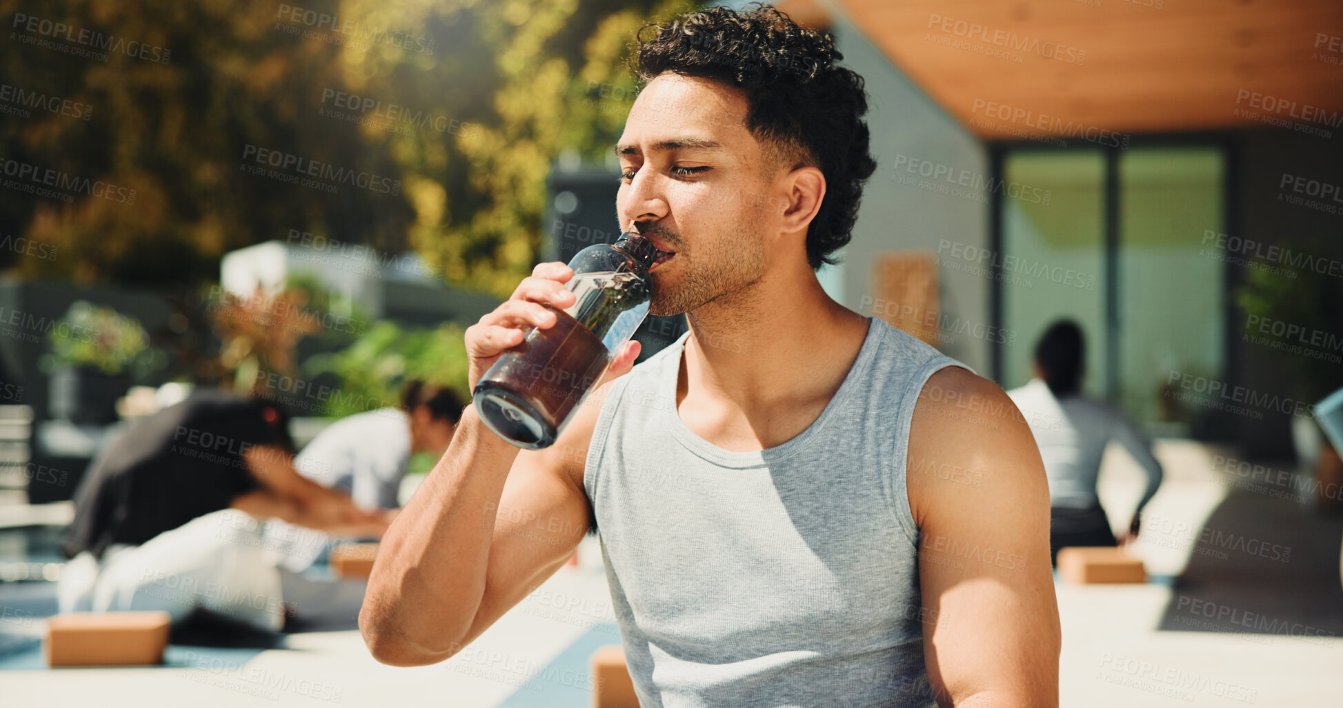 Buy stock photo Drinking, outdoor and man with water at yoga class for break, relax or recovery on wellness retreat. Calm, rest and male person with healthy beverage for hydration at pilates session on holiday.