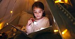 Kid, torch and reading book in tent at night for fairytale, bedtime storytelling and literature. Child, flashlight and fantasy novel with folklore story, imagination and language development at house