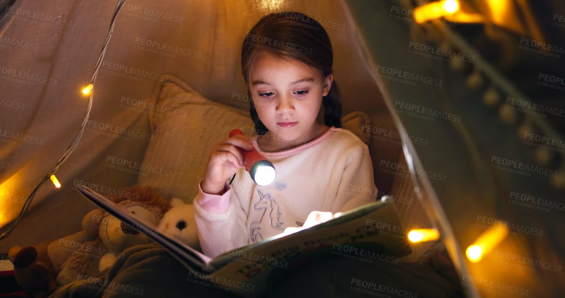 Buy stock photo Kid, torch and reading book in tent at night for fairytale, bedtime storytelling and literature. Child, flashlight and fantasy novel with folklore story, imagination and language development at house