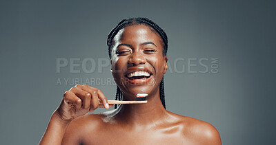 Buy stock photo Bamboo toothbrush, dental health and black woman laugh for oral wellness, fresh breath and gum care. Toothpaste, eco friendly and funny person with natural orthodontics in studio on gray background