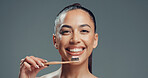 Dental health, portrait and woman with bamboo toothbrush for oral wellness, fresh breath or gum care. Toothpaste, clean teeth and face of person with eco friendly tool in studio on gray background