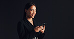 Phone, smile and businesswoman in studio with networking, communication or social media on app. Technology, typing and female person with cellphone for email, online or contact by black background.