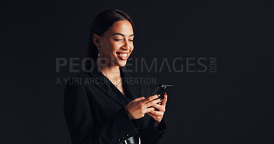 Buy stock photo Phone, smile and businesswoman in studio with networking, communication or social media on app. Technology, typing and female person with cellphone for email, online or contact by black background.