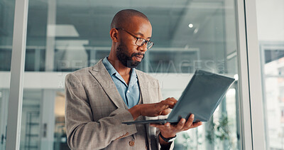 Buy stock photo Online, research and businessman with laptop, office and financial analysis on web, typing and info. Investment banker, black person and plan for pitch with technology, wealth management or low angle