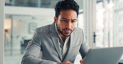 Buy stock photo Reading, online and businessman with laptop, office and financial analysis on web, info and research. Investment banker, person and planning for pitch with tech, review and checking market data