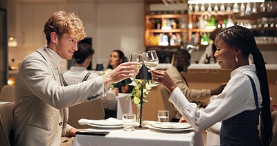 Buy stock photo Couple, toast champagne and happy at restaurant, night and celebration for interracial love on date. Man, woman and excited for drinks, romance or milestone with dinner, bonding or relationship goals