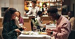 Couple, eating dinner and night at restaurant on date, bonding or happy for fine dining with lasagna. Woman, man and relationship, food and gourmet meal with customer experience with cuisine at diner