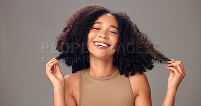 Buy stock photo Haircare, portrait and woman in studio, laugh or maintenance of texture, shine and gray background. Happy, African person and confident for healthy hair, growth and self care for hairstyle and glow