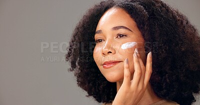 Buy stock photo Skincare, cream and woman in studio, happy or healthy skin with cosmetics, thinking and mockup space. Anti aging, face and person with lotion for glow, gray background and self care with dermatology