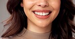 Mouth, closeup and woman in studio. smile and beauty with dental hygiene on gray background. Happy, teeth whitening and person with oral health, skincare and fresh breath with cosmetics and wellness