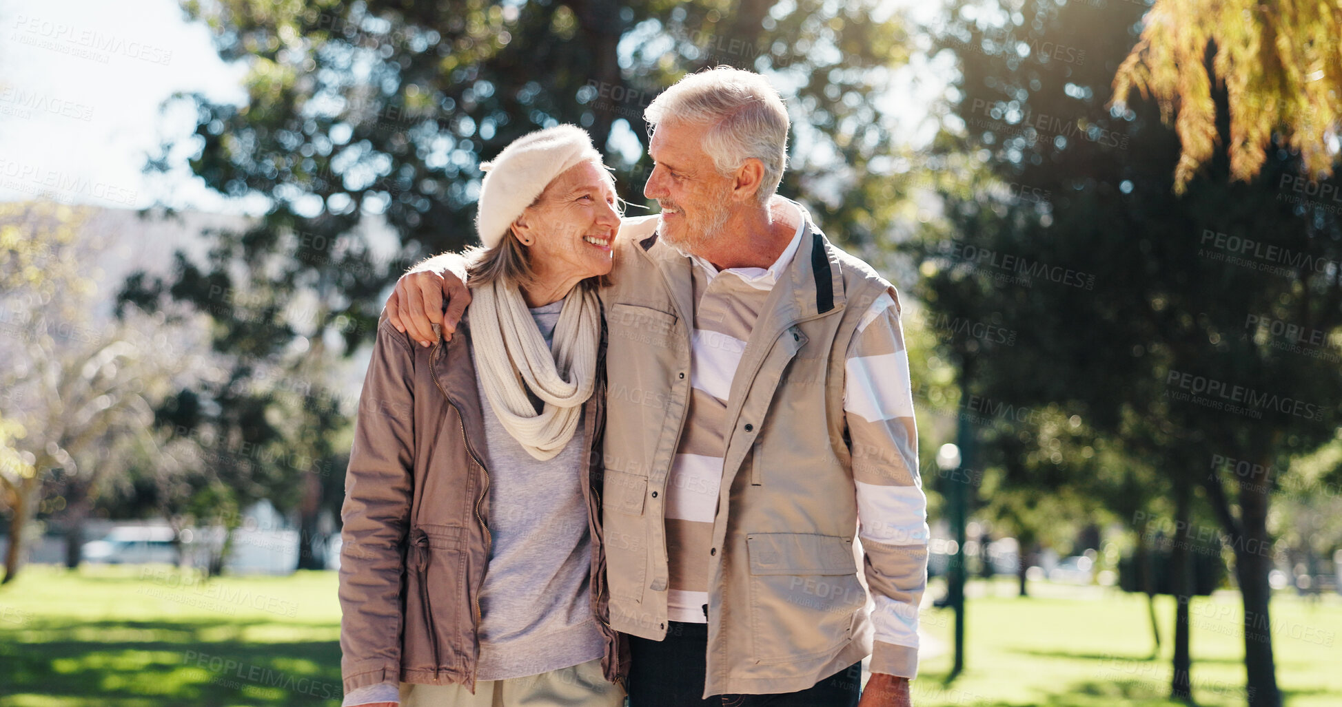 Buy stock photo Retirement, walking and couple in nature with hug, love and bonding together in happy marriage. Romance, old man or woman in park with embrace, connection or outdoor stroll in healthy relationship.
