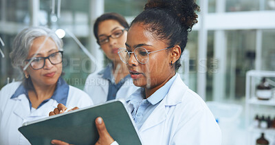 Buy stock photo Medical, glass wall and women in lab with tablet, collaboration and notes for genetic study. Science, support and researcher in clinic with idea board, problem solving and analysis of dna formula.