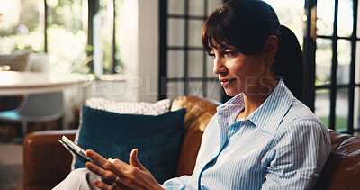 Buy stock photo Home, tablet and woman on sofa, typing and online reading with social media, relax and internet. Apartment, tech and mature person on couch, ebook and network with connection, app and communication