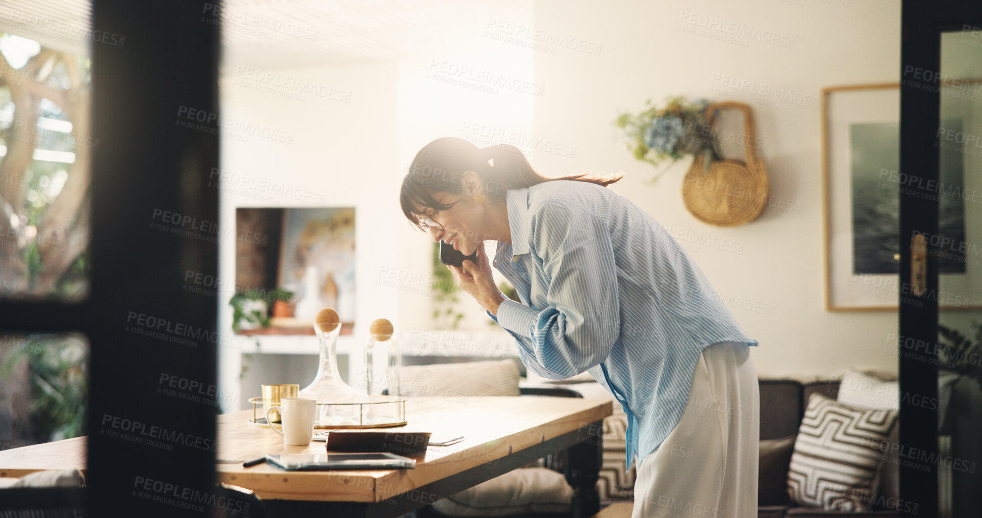 Buy stock photo Woman, phone call and notebook with talking in home for venue booking, date schedule and remote work. Freelancer, event planner and contact client on patio for vendor negotiation and planning process