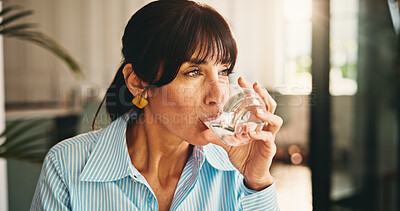 Buy stock photo Home, woman and glass with water for wellness, hydration and benefits for gut health in living room. House, lounge and mature person with h2o drink for thirst, detox or nutrition in apartment