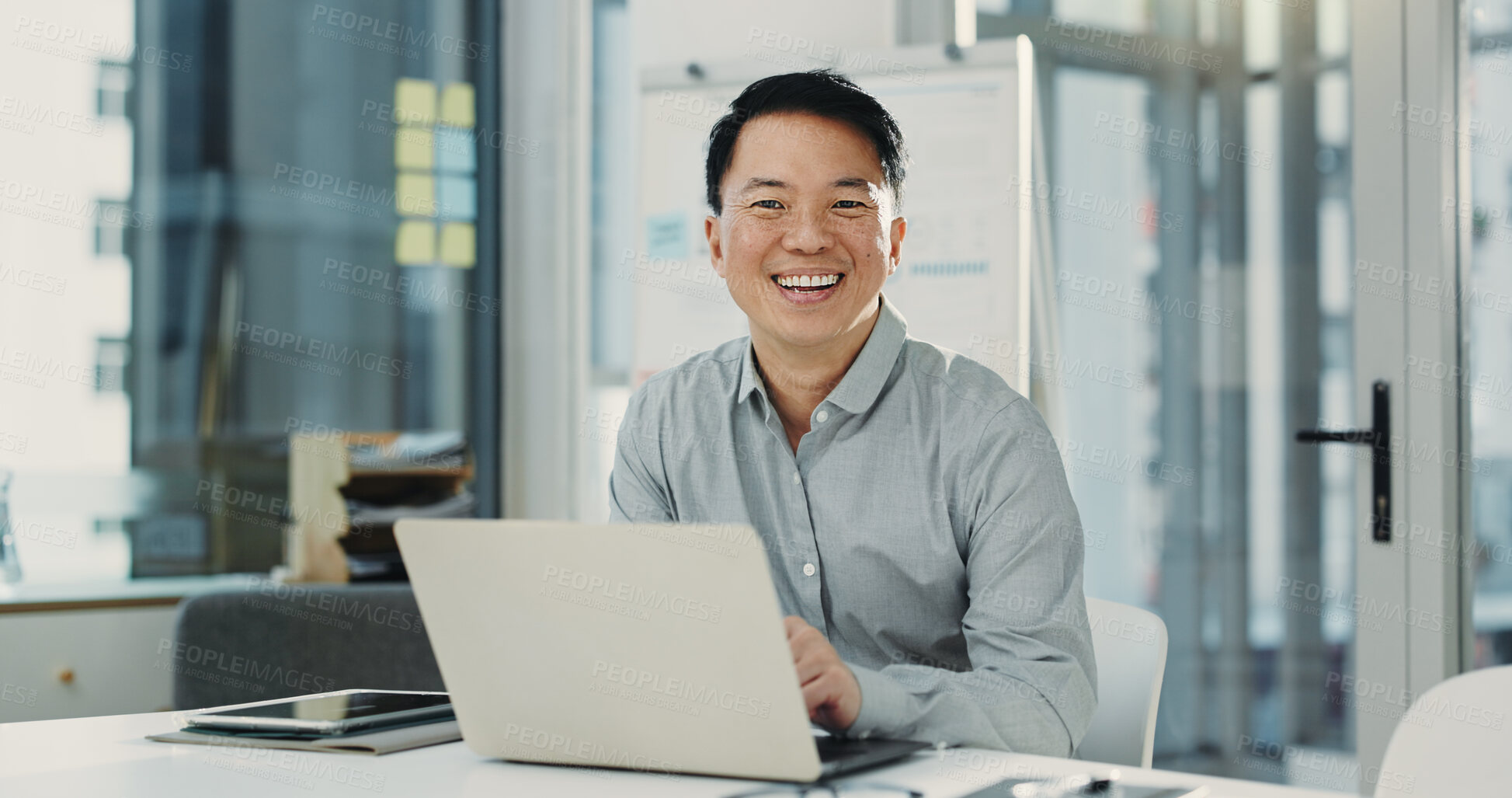 Buy stock photo Portrait, laptop and Asian man in office for business, compliance consultant and laugh. Computer, happy advisor and mature person with pride for policy development, confidence or funny in South Korea