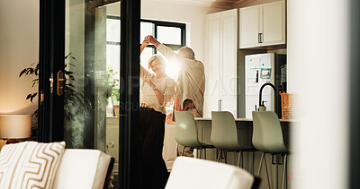 Buy stock photo Elderly couple, love and dance in home for connection, marriage anniversary and spin. Romantic music, senior man and woman holding hands in kitchen for retirement, healthy relationship and smile