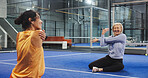 Women, coach and stretching arms at padel club, smile and advice for training, routine and talk. Personal trainer, senior person and happy with warm up, fitness and chat with exercise on tennis court