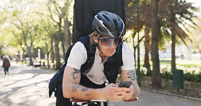 Buy stock photo Delivery, bike and phone with man in park for package distribution, courier route app and shipping. Online order, cycling and ecommerce parcel with person and mobile outdoor for export and cargo